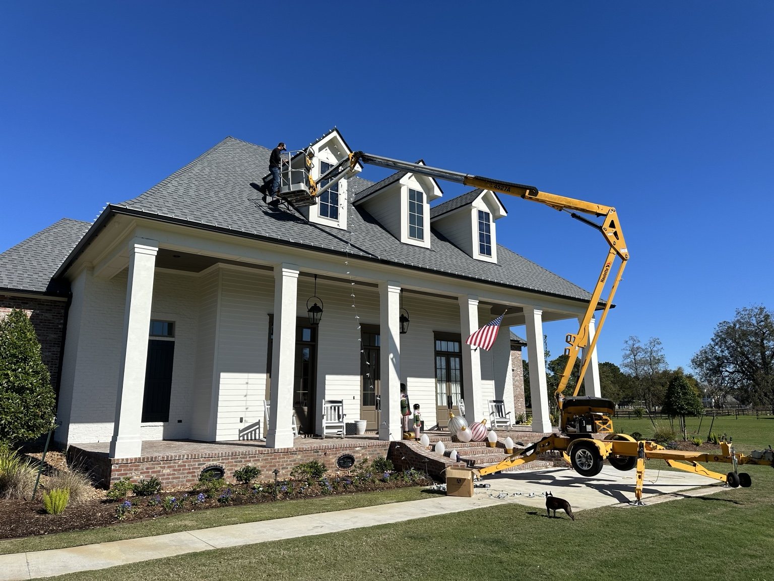 Professional lift used to install Christmas lights on a high roof