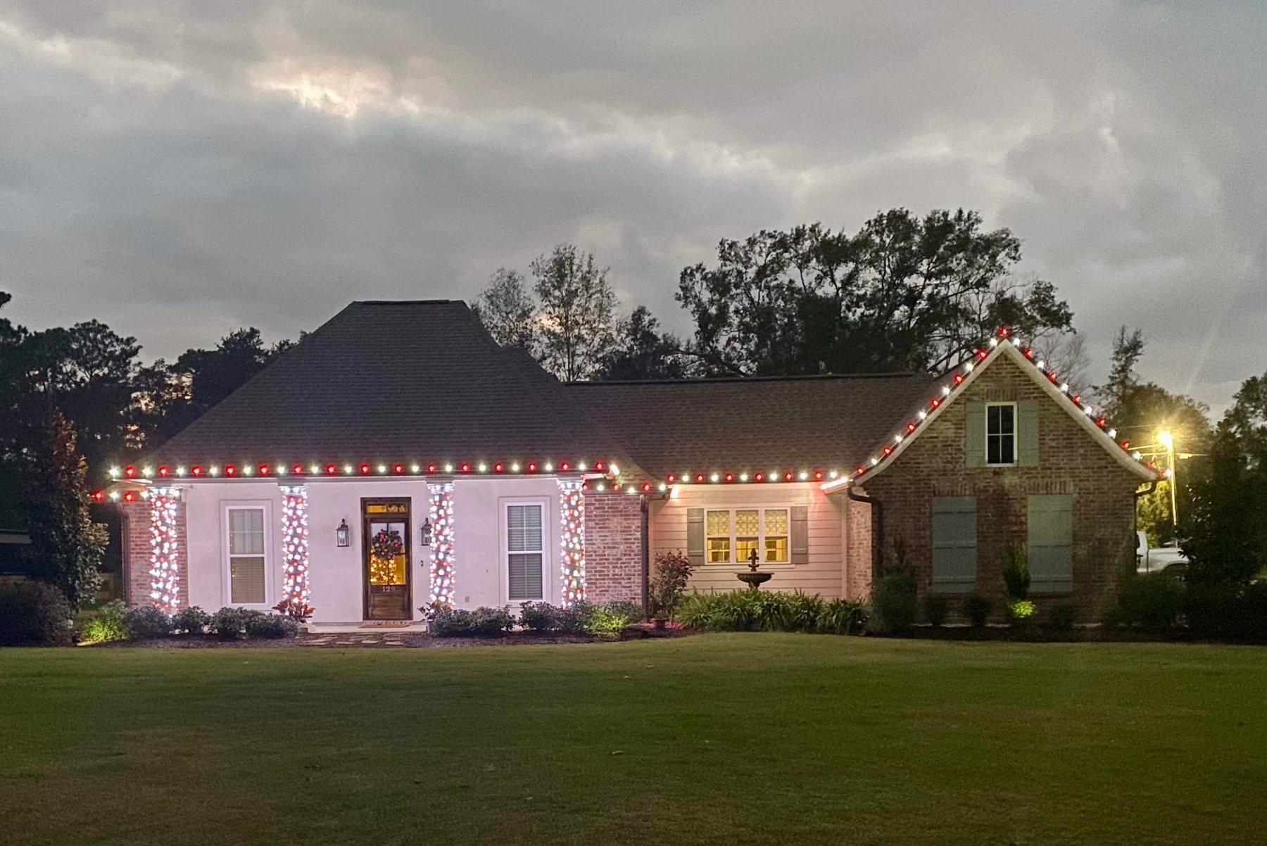 Red and white custom Christmas roofline lighting