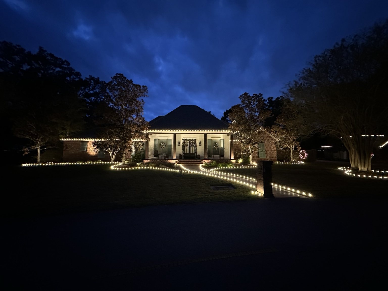 Finished custom holiday lighting installation matching the design shown above